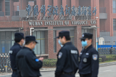 Security personnel stand guard outside the Wuhan Institute of Virology in Wuhan in China's central Hubei province on February 3, 2021. 