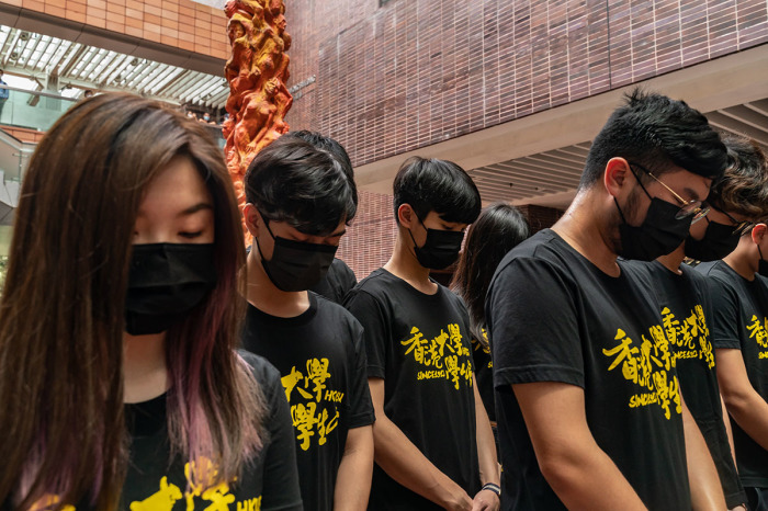 University students take a moment of silence as they gather to clean the Pillar of Shame sculpture by Danish artist Jens Galschiot, to remember the victims of the Tiananmen crackdown in Beijing, at the University of Hong Kong on June 4, 2021 in Hong Kong, China. Hong Kong activists planned private vigils and religious services to commemorate China's deadly Tiananmen Square crackdown in 1989, as a prominent organizer was arrested and thousands of police were deployed to prevent any mass protests. 