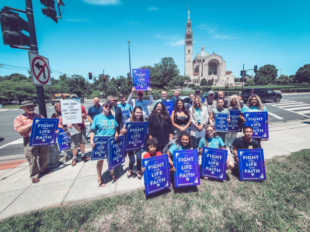 Pro-life activists pose in front of the Basilica of the Immaculate Conception in Washington, D.C., after holding a 'Fight for Life & Faith' rally calling on Cardinal Wilton Gregory to support a draft document advising local ordinaries to withhold communion from pro-abortion Catholic politicians, June 16, 2021.