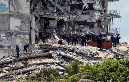 Members of the South Florida Urban Search and Rescue team look for possible survivors in the partially collapsed 12-story Champlain Towers South condo building on June 26, 2021, in Surfside, Florida.