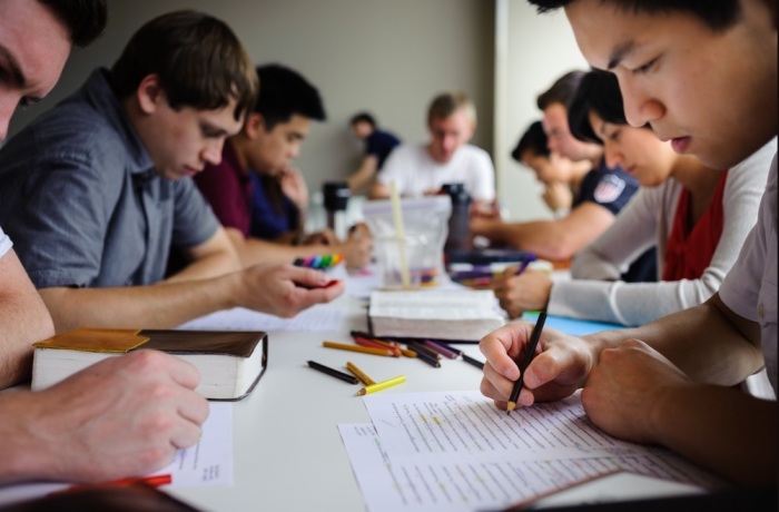 Students belonging to InterVarsity Christian Fellowship engaging in a Bible study. 