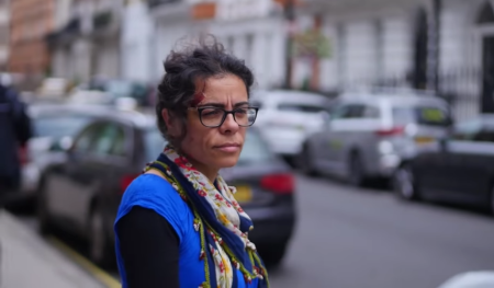 Hatun Tash walks on a London sidewalk. 