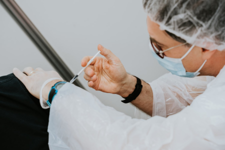 A health worker delivers a vaccine shot into an arm in this undated file photo. 