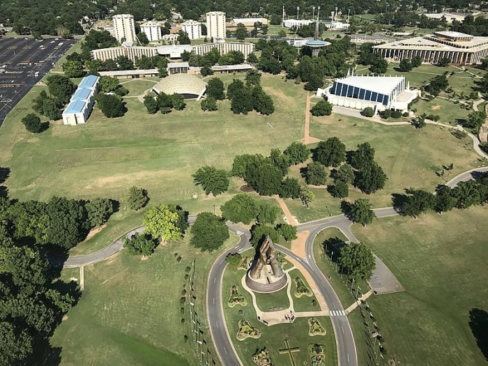 A sculpture of large praying hands sits at the entrance of Oral Roberts University in Tulsa, Oklahoma in summer 2017.