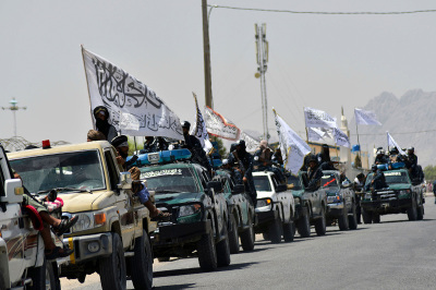 Taliban fighters parade along a road to celebrate after the United States pulled all its troops out of Afghanistan, in Kandahar on September 1, 2021 following the Taliban's military takeover.