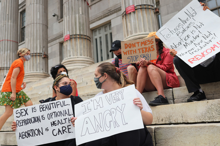 People gather for a reproductive rights rally at Brooklyn Borough Hall on September 01, 2021, in Downtown Brooklyn in New York City. NOW-NYC and Planned Parenthood of Greater New York Action Fund organized a rally for reproductive rights after a Texas law that has been dubbed the 'Heartbeat Bill' went into effect. The law ends access to abortion after six weeks of pregnancy and would allow anyone to sue abortion providers and “aiders and abetters” in civil court. Abortion rights activists have asked the Supreme Court to block the law, but as of Wednesday morning the court has allowed the law to go into effect. In May, Supreme Court justices agreed to review a Mississippi case on the state's ban on abortion procedures after 15 weeks of pregnancy, a direct challenge to Roe v. Wade, the 1973 landmark decision that legalized abortion nationwide. A ruling on that case is expected in 2022. 