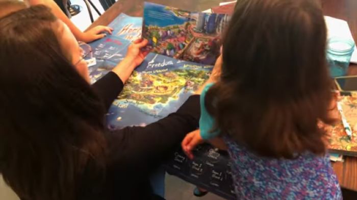 A woman reads a book published by Brave Books to children. 