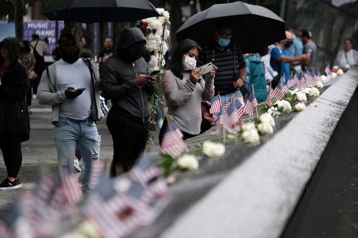 People pause at the September 11th Memorial on September 9, 2021, in New York City. New York City and much of the nation are preparing for the 20th anniversary of the terrorist attacks in both New York City and Washington D.C. The United States has officially ended its participation in the war in Afghanistan, a two-decade-long conflict that began shortly after the terrorist attacks of September 11, 2001. Almost 2,500 U.S. service members have died in the conflict, and thousands of Afghan troops, police personnel and civilians have also been killed.