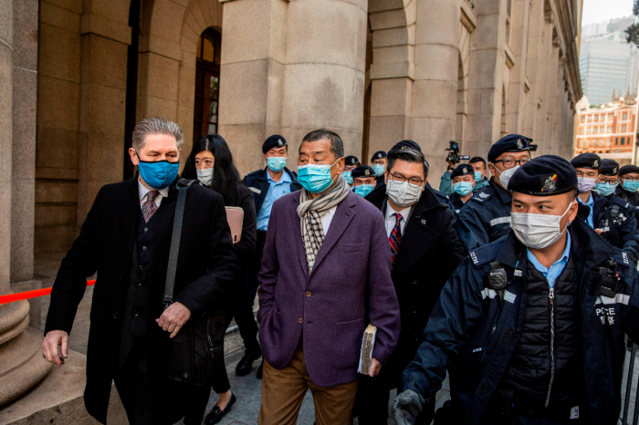 Hong Kong pro-democracy media tycoon Jimmy Lai (C) leaves the Court of Final Appeal in Hong Kong on December 31, 2020, during a break pending the court's decision on the prosecution's appeal against his bail after he was charged with the new national security law. 