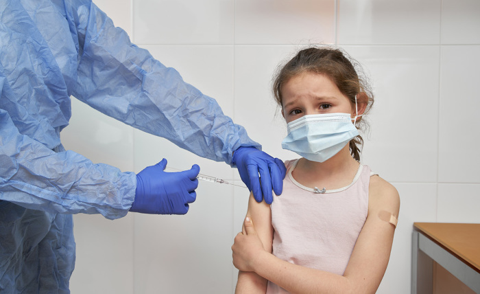 Girl receiving a vaccine for COVID-19