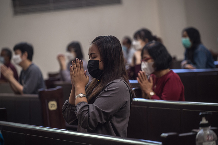 Christians gather at a church for Easter mass on April 4, 2021, in Surabaya amid tight police security following the March 28 a bombing at the Makassar cathedral on Palm Sunday.