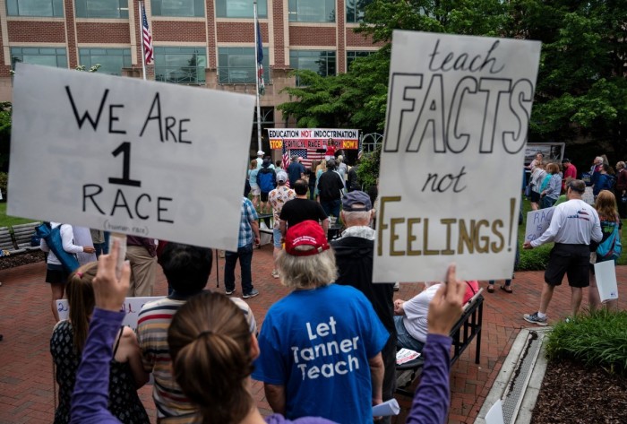 People hold up signs during a rally against “critical race theory” (CRT) being taught in schools at the Loudoun County Government center in Leesburg, Virginia on June 12, 2021. “Are you ready to take back our schools?” Republican activist Patti Menders shouted at a rally opposing anti-racism teaching that critics like her say trains white children to see themselves as “oppressors.” “Yes!”, answered in unison the hundreds of demonstrators gathered this weekend near Washington to fight against “critical race theory,” the latest battleground of America’s ongoing culture wars.