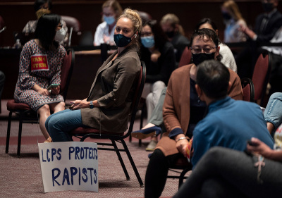 A woman sits with her sign during a Loudoun County Public Schools (LCPS) board meeting in Ashburn, Virginia, on October 12, 2021. - Loudoun county school board meetings have become tense recently with parents clashing with board members over transgender acticism in the school system, the teaching of critical race theory (CRT) and ongoing COVID-19 mandates. Recently tensions between groups of parents and the school board increased after a trans-identified boy sexually assaulted two girls. Earlier this month, U.S. Attorney General Merrick Garland directed the FBI to investigate parents or anyone else deemed to have made a threat against a school board member or teacher. This is in response to a request from the National School Boards Association asking U.S. President Joe Biden for federal assistance to investigate and stop threats made over policies including mask mandates, likening the vitriol to a form of domestic terrorism. 