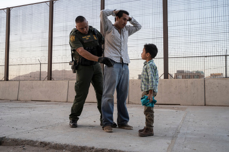 José, 27, with his son José Daniel, 6, is searched by US Customs and Border Protection Agent Frank Pino, May 16, 2019, in El Paso, Texas. Father and son spent a month trekking across Mexico from Guatemala. - About 1,100 migrants from Central America and other countries are crossing into the El Paso border sector each day. U.S. Customs and Border Protection Public Information Officer Frank Pino, says that Border Patrol resources and personnel are being stretched by the ongoing migrant crisis, and that the real targets of the Border Patrol are slipping through the cracks. 