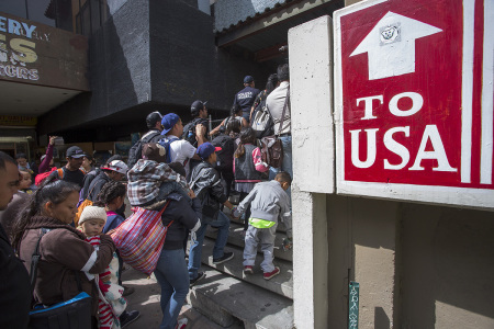 Members of a caravan of Central Americans who spent weeks traveling across Mexico walk from Mexico to the U.S. side of the border on April 29, 2018, in Tijuana, Baja California Norte, Mexico. 