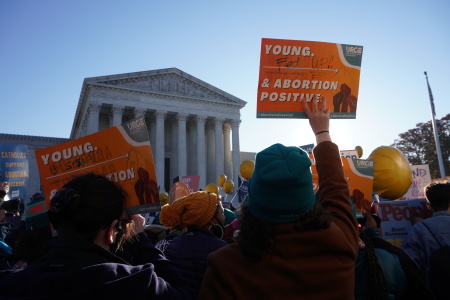 Demonstrators stand outside the U.S. Supreme Court building in Washington, D.C. during the oral arguments for Dobbs v. Jackson’s Women’s Health on Dec. 1, 2021.