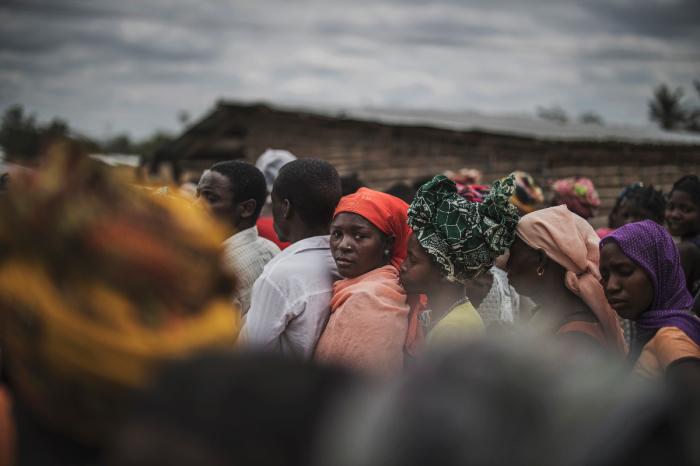 Residents gather for a distribution of utensils organised by the Catholic relief organisation CARITAS in the village of Muagamula, outside Macomia, northern Mozambique on August 24, 2019. 