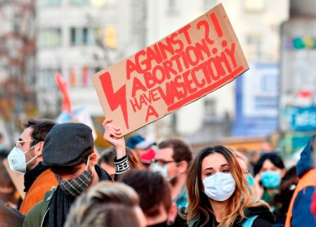 A demonstrator holds up a placard during a demonstration against Poland's near-total ban on abortion in Berlin, Germany, on Nov. 7, 2020.