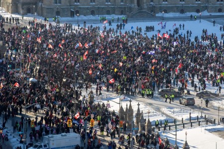 Supporters arrive at Parliament Hill for the Freedom Truck Convoy to protest against Covid-19 vaccine mandates and restrictions in Ottawa, Canada, on January 29, 2022. Hundreds of truckers drove their giant rigs into the Canadian capital Ottawa on Saturday as part of a self-titled 'Freedom Convoy' to protest vaccine mandates required to cross the US border.