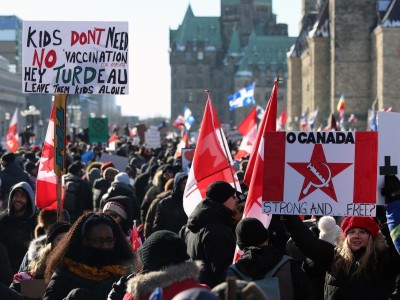 Supporters of the Freedom Convoy protest Covid-19 vaccine mandates and restrictions in front of Parliament on January 29, 2022 in Ottawa, Canada. - Hundreds of truckers drove their giant rigs into the Canadian capital Ottawa on Saturday as part of a self-titled 'Freedom Convoy' to protest vaccine mandates required to cross the US border.