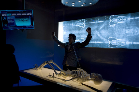 An official gestures as he speaks next to a facsimile of 'The Shroud of Turin' at the Cathedral of Malaga, on February 20, 2012. 