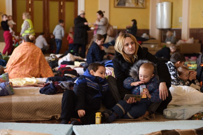 Women with small children fleeing the Russian invasion of Ukraine get settled at the train station of the western Ukrainian city of Lviv on March 11, 2022. 