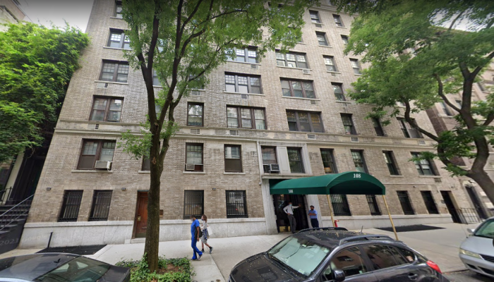 Bystanders walk by the building at 108 E 82nd Street, New York, NY 10028.