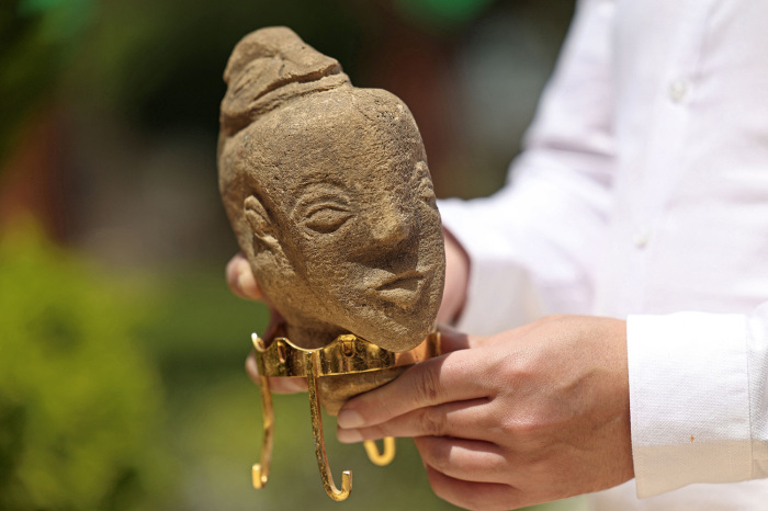 A newly-discovered stone statuette over 4,500 years old depicting the face of an ancient goddess, is displayed during a press conference at the Ministry of Antiquities and Tourism in Gaza City on April 26, 2022. 