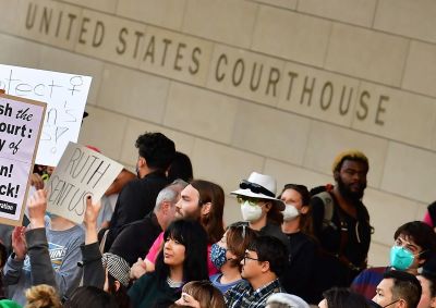 A person holds up a sign reading 'Ruth Sent Us' as pro-choice activists gather outside the U.S. Courthouse to defend abortion rights in downtown Los Angeles on May 3, 2022. 