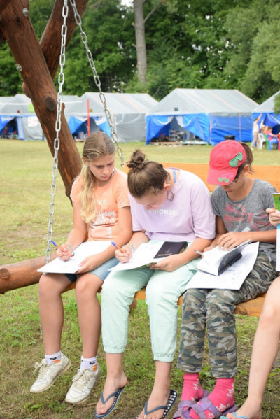 Girls at camp writing in journals