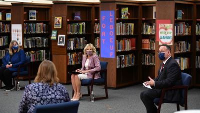 US First Lady Jill Biden (C) and Education Secretary Miguel Cardona (R) listen to parents as they tour Fort LeBoeuf Middle School in Waterford, Pennsylvania, on March 3, 2021. 