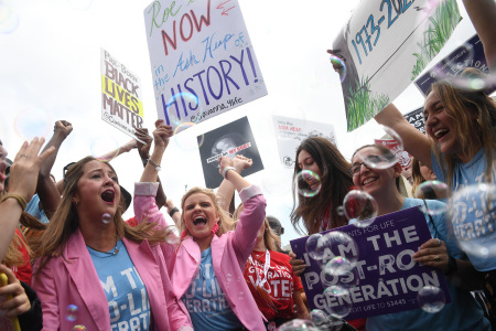 Pro-life campaigners celebrate outside the U.S. Supreme Court in Washington, D.C., on June 24, 2022. - The U.S. Supreme Court on Friday ended legalized abortion nationwide, one of the most divisive and bitterly fought issues in American politics. The court overturned the landmark 1973 Roe v. Wade decision and said individual states can permit or restrict the procedure themselves. 