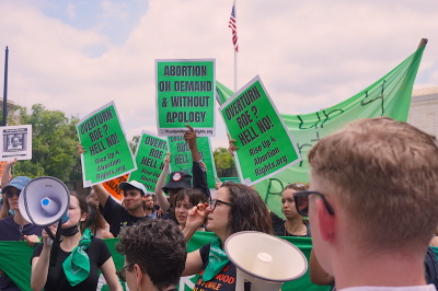 Participants in a rally outside the Supreme Court of the United States in Washington D.C. held signs expressing their stance on abortion following the Dobbs v. Jackson Women's Health Organization decision, June 24, 2022. 