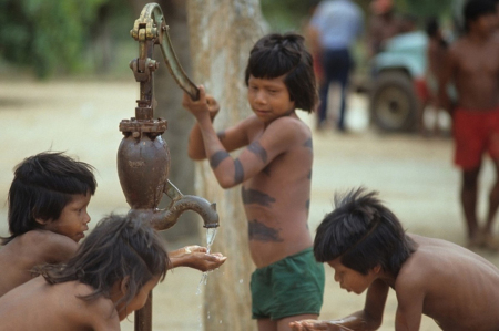 Children use a water pump built under Wycliffe's Operation Clean Water initiative.