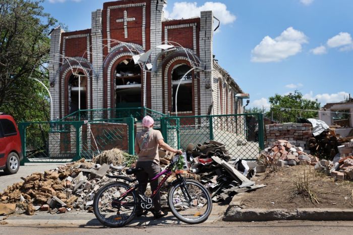 Worshipers leave Sunday service at Sukovska Baptist church on June 19, 2022, in Druzhkivka, Ukraine. Services were held in a small tent in the back of the church because the building was heavily damaged by a recent missile strike. In recent weeks, Russia has concentrated its firepower on Ukraine's Donbas region, where it has long backed two separatist regions at war with the Ukrainian government since 2014. 