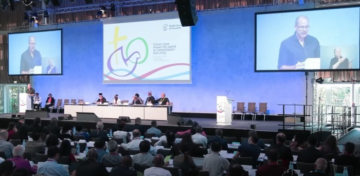 Audience members attend a business plenary session at the World Council of Churches 11th Assembly on Monday, Sept. 5, 2022, in Karlsruhe, Germany. 