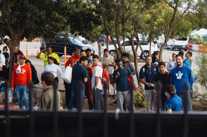 Migrants sit outside the Migrant Resource Center on September 19, 2022, in San Antonio, Texas. The San Antonio Migrant Resource Center is the place of origin of the two planeloads of mostly Venezuelan migrants who were sent via Florida to Martha's Vineyard in Massachusetts by Florida Gov. Ron DeSantis.