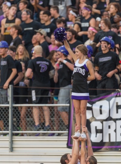 Emma Benoit in high school as a varsity cheerleader 