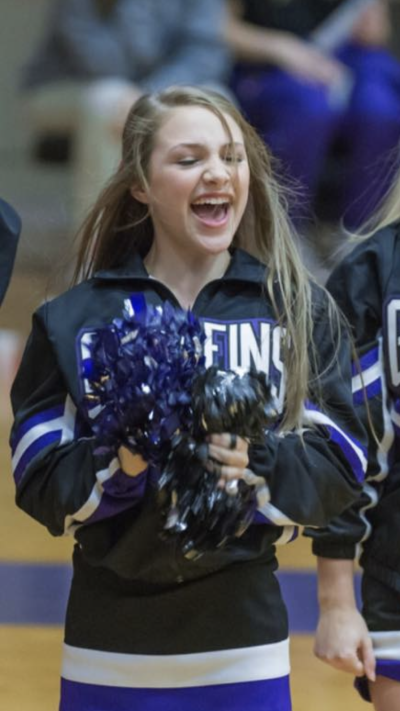 Emma Benoit in her high school years as a varsity cheerleader 