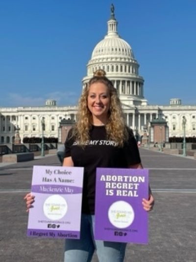 Krissy Spivey stands in Washington, D.C., holding pro-life signs.