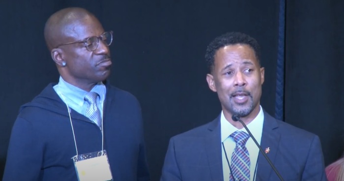 The Rev. Cedrick Bridgeforth (right), gives remarks on Friday, Nov. 4, 2022, shortly after being elected by delegates of the Western Jurisdiction to be the first openly gay black bishop in The United Methodist Church. 