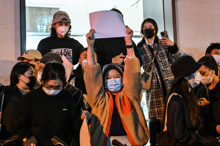 People show blank papers as a way to protest, is seen on a wall while gathering on a street in Shanghai on Nov. 27, 2022, where protests against China's zero-Covid policy took place the night before following a deadly fire in Urumqi, the capital of the Xinjiang region. 