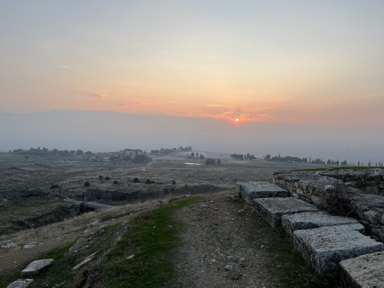 The sun sets over the remains of ancient Hierapolis in Denizli, Turkey.