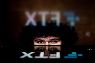 This photo illustration shows the logo of cryptocurrency FTX, reflected in an image of former chief executive Samuel Bankman-Fried, in Washington, DC, on November 13, 2022. - The new chief executive of troubled cryptocurrency platform FTX said on November 12, 2022, the company was making 'every effort to secure all assets' following unauthorized transactions potentially worth hundreds of millions of dollars. Additionally, the platform's chief executive, 30-year-old Sam Bankman-Fried, once considered a star in the freewheeling cryptocurrency world, resigned.