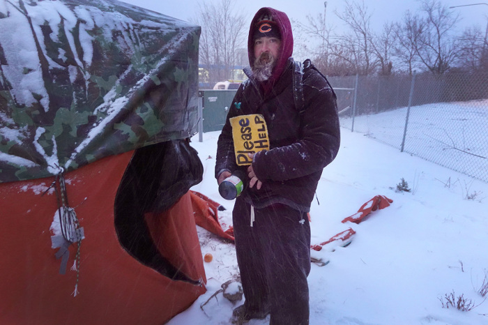 Pete, a 41-year-old homeless man, stands next to the donated tent near the expressway where he is living as temperatures hang in the single-digits on Dec. 22, 2022, in Chicago, Illinois. A winter weather system bringing snow, high winds and sub-zero temperatures has wreaked havoc on a large section of the county in front of the holidays. Strong winds are expected to combine with sub-zero temperatures tomorrow driving the wind chill in Chicago to around -40 degrees.