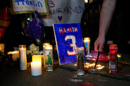 Fans hold a candlelight vigil for Buffalo Bills safety Damar Hamlin at the University of Cincinnati Medical Center on Jan. 3, 2023, in Cincinnati, Ohio. Hamlin suffered cardiac arrest and is in critical condition following the Bills' Monday Night Football game against the Cincinnati Bengals. 