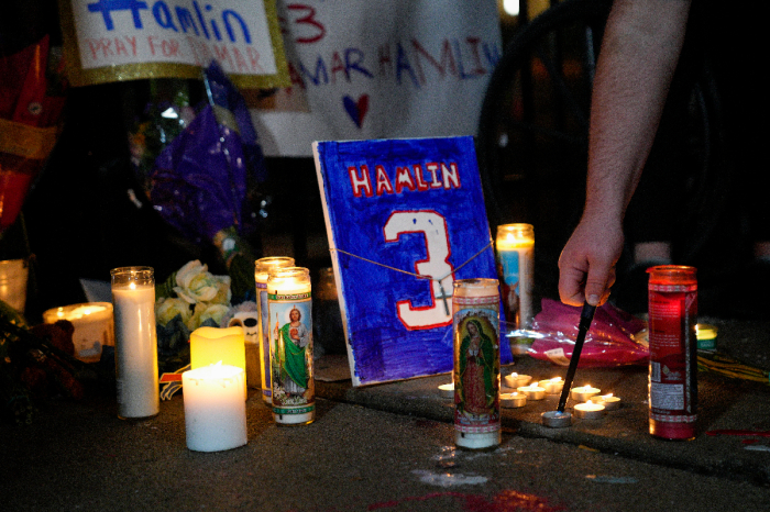 Fans hold a candlelight vigil for Buffalo Bills safety Damar Hamlin at University of Cincinnati Medical Center on Jan. 3, 2023 in Cincinnati, Ohio. Hamlin suffered cardiac arrest and is in critical condition following the Bills' Monday Night Football game against the Cincinnati Bengals. 