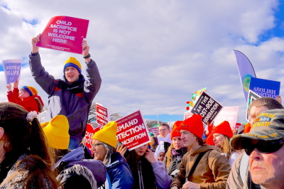 A pro-lifer holds a sign in the air at the March for life 2023 event which states: 'Child Sacrifice is Not Welcome Here.' The march took place on Jan. 20 in Washington DC. 