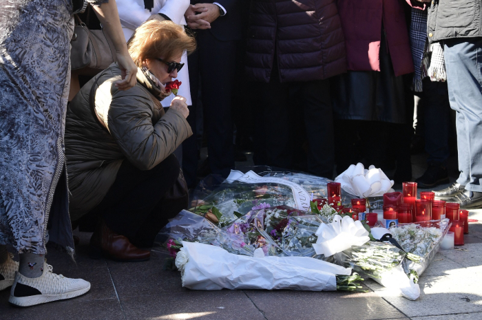 Relatives and friends of the victim react during a minute of silence near the church where a sacristan (priest's assistant) was killed the day before on Alta square in Algeciras, southern Spain, on January 26, 2023. - Spain opened a terror probe on January 25 after a man wielding a bladed weapon stormed a church in southern Spain, killing a sacristan and wounding severely a priest, legal sources told AFP. 