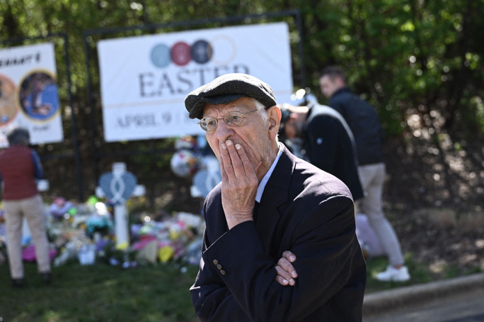 People gather at a makeshift memorial for victims of a shooting at The Covenant School campus, in Nashville, Tennessee, March 29, 2023. - A heavily armed trans-identified woman killed three young children and three staff in what appeared to be a carefully planned attack at a private Christian elementary school in Nashville on March 27, 2023, before being shot dead by police. Chief of Police John Drake named the suspect as Audrey Hale, 28, who the officer later said identified as transgender. 